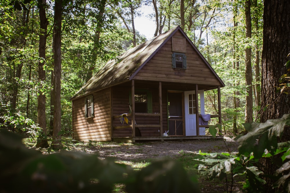 brown wooden house near trees during daytime