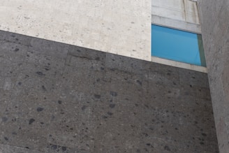 Renovated historic building blending old stone walls and modern glass.