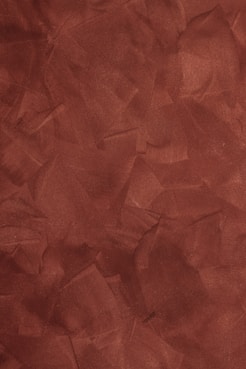 a red background with a rough texture of paper