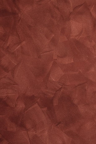 a red background with a rough texture of paper