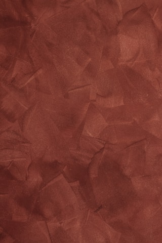 a red background with a rough texture of paper