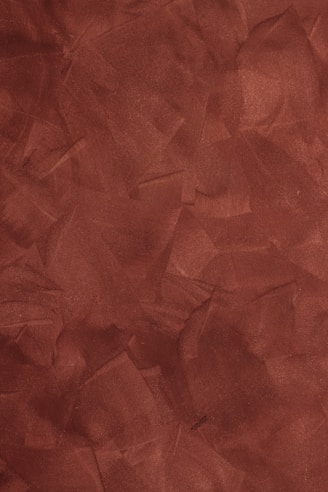 a red background with a rough texture of paper