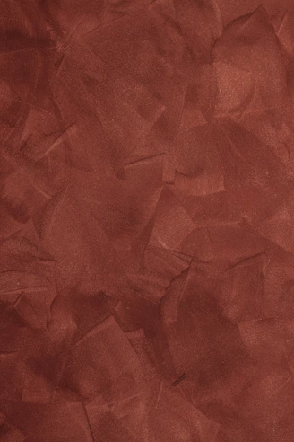a red background with a rough texture of paper