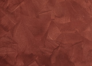 a red background with a rough texture of paper