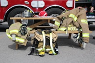 Team members gathered around a fire engine, preparing equipment before heading out.