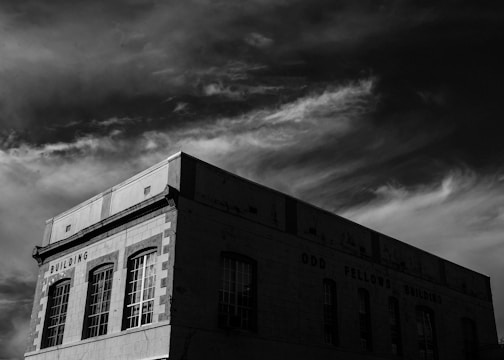 Historic black and white photo of the original Solomon Grand Lodge meeting hall with early members gathered.