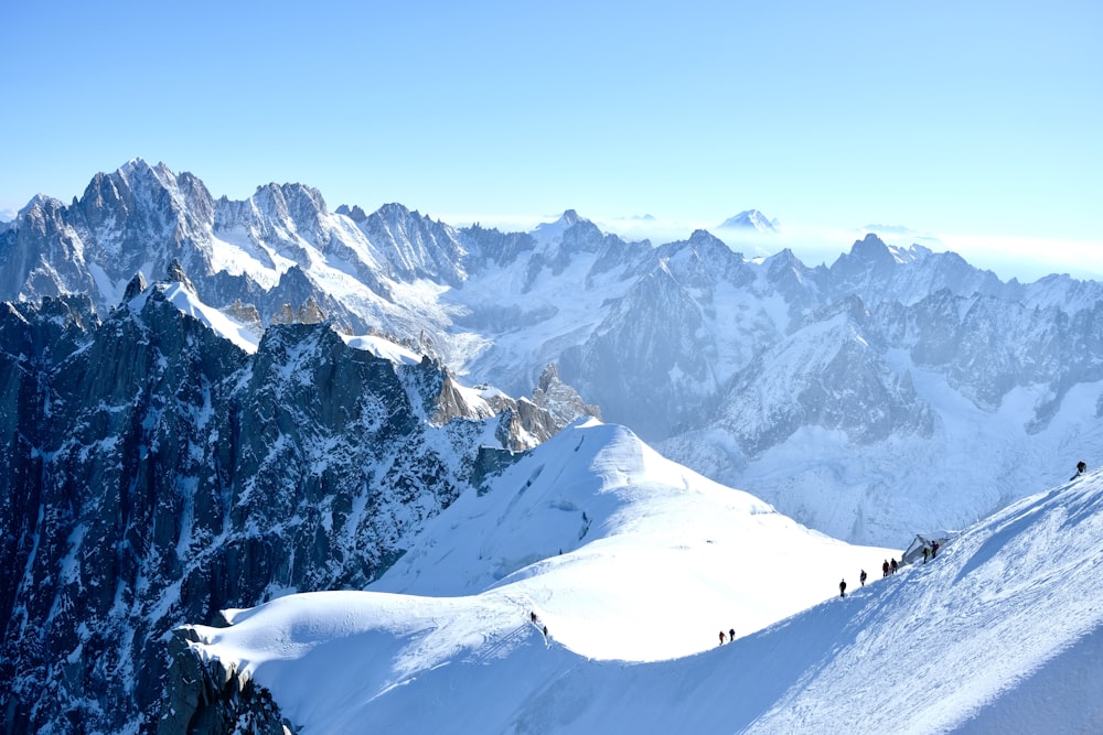 people hiking on snow mountain