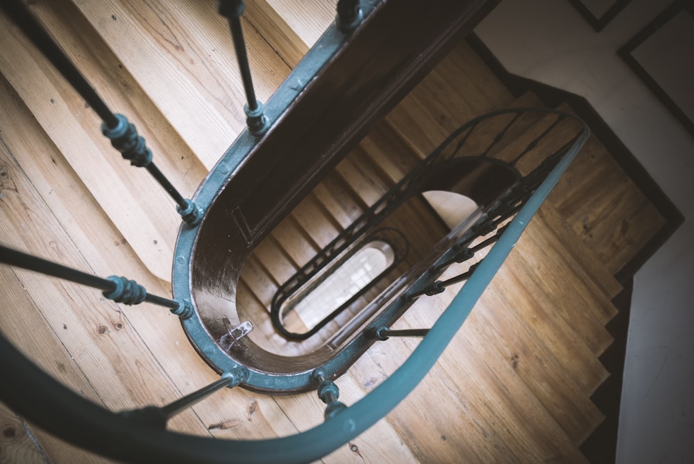 brown wooden spiral staircase with blue baluster