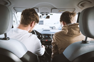 two men sitting inside vehicle