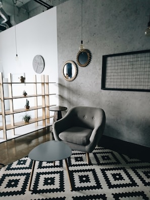 gray padded couch in front of wooden center table