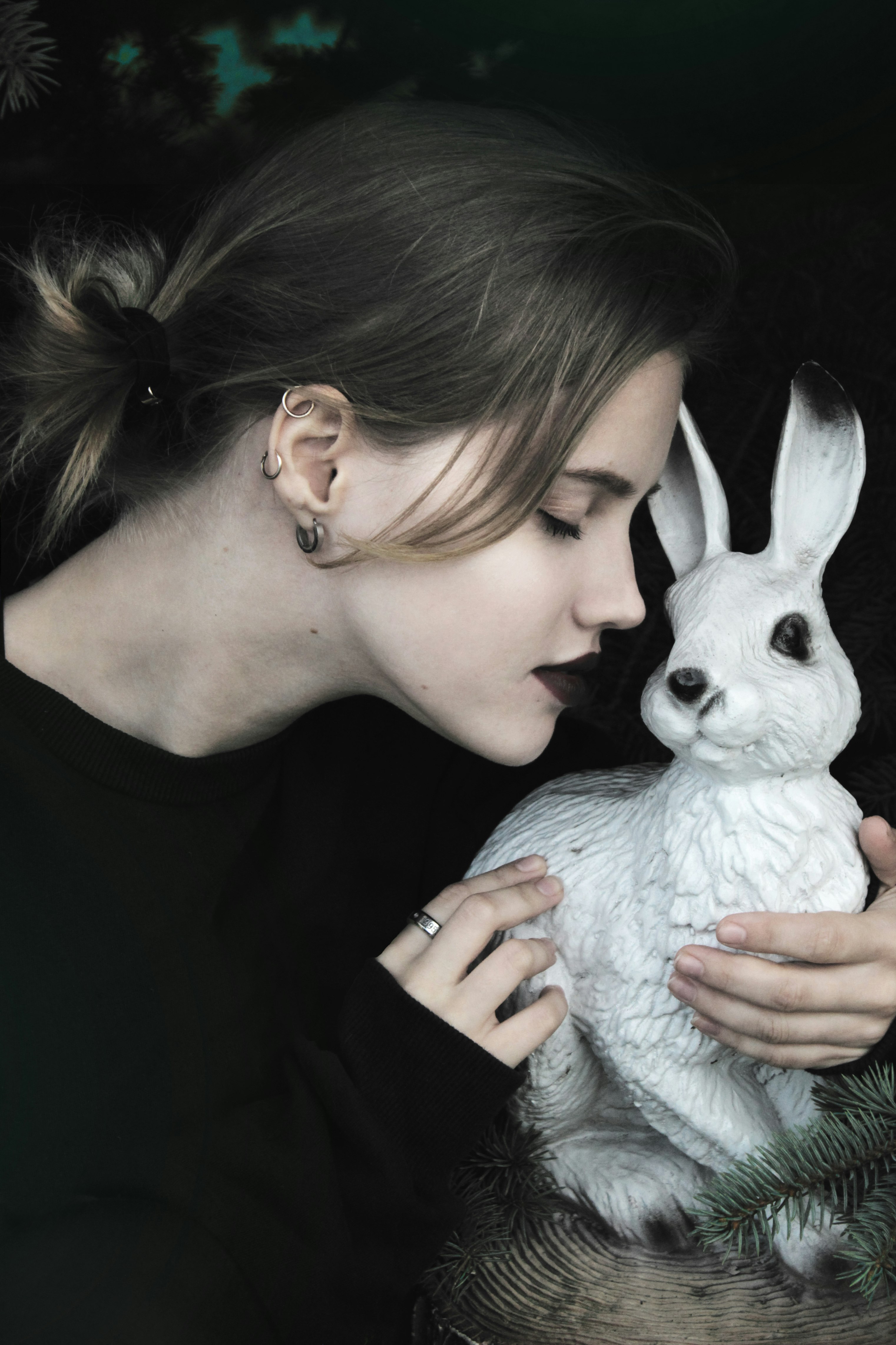 woman hugging white rabbit figurine