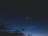 A serene night sky with a glowing crescent moon and twinkling stars reflecting calm and guidance.