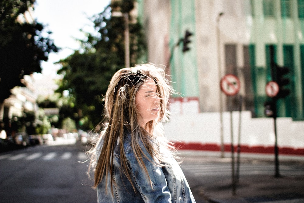 woman standing near asphalt road