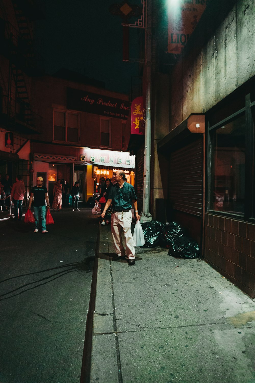 man walking on street during night