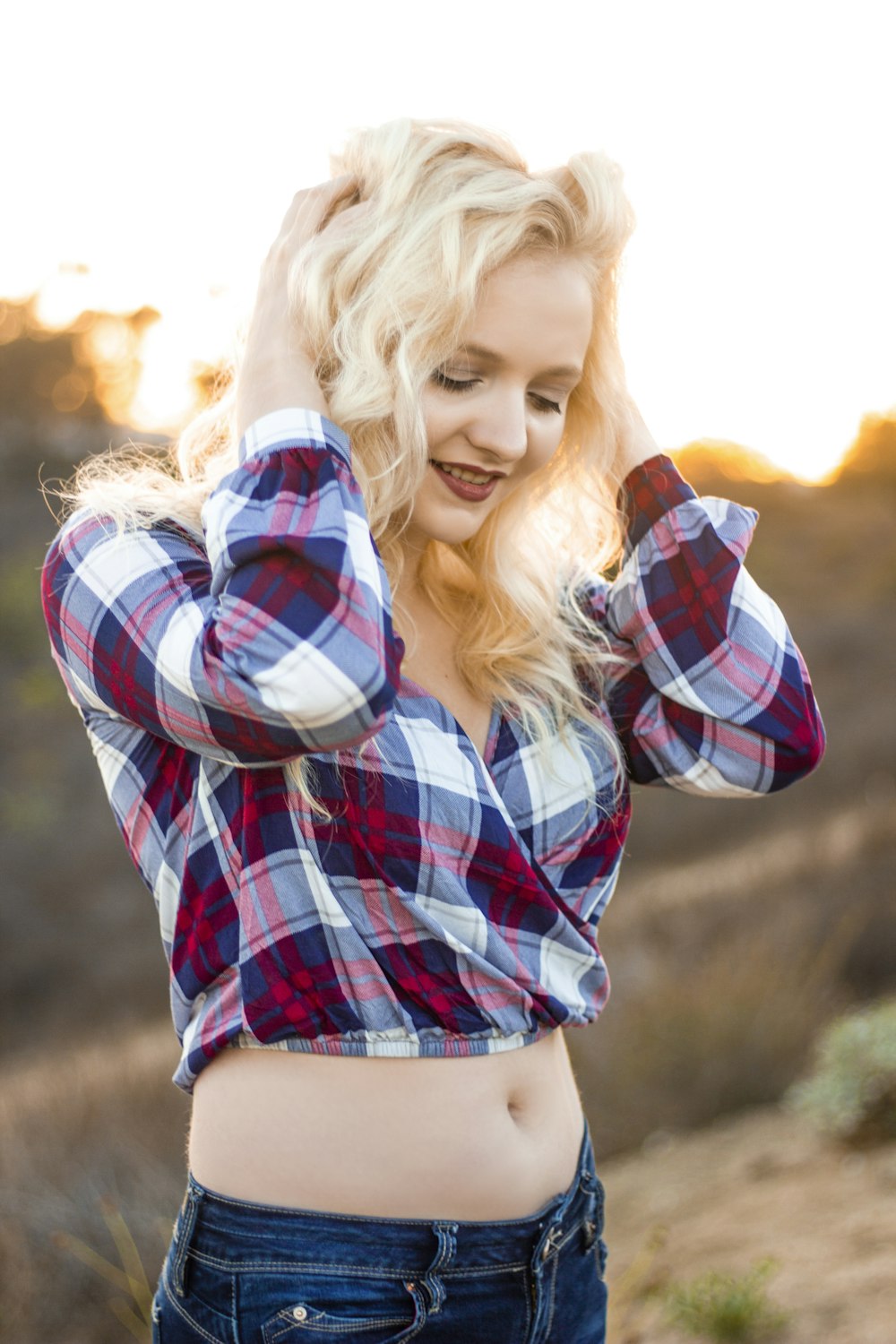 woman wearing crop top holding her head