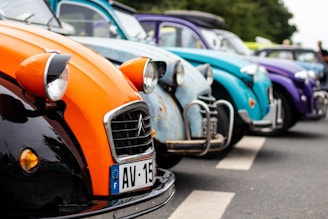 A group of vintage cars lined up at a car show.