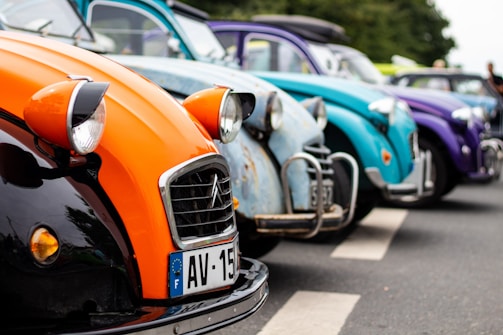 A group of vintage cars lined up at a car show.