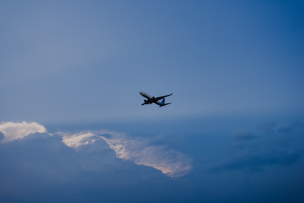 brown plane flying on the sky photography