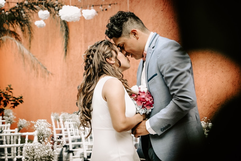 couple beside white fence