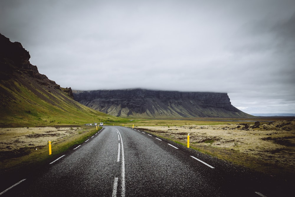 blacktop road near gray mountain