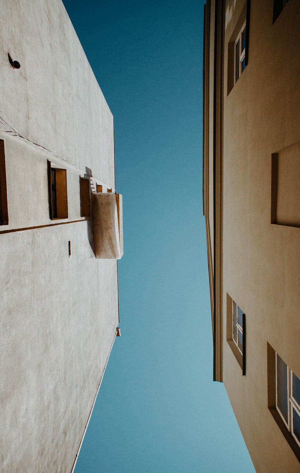 white and beige concrete buildings under gray sky during daytime