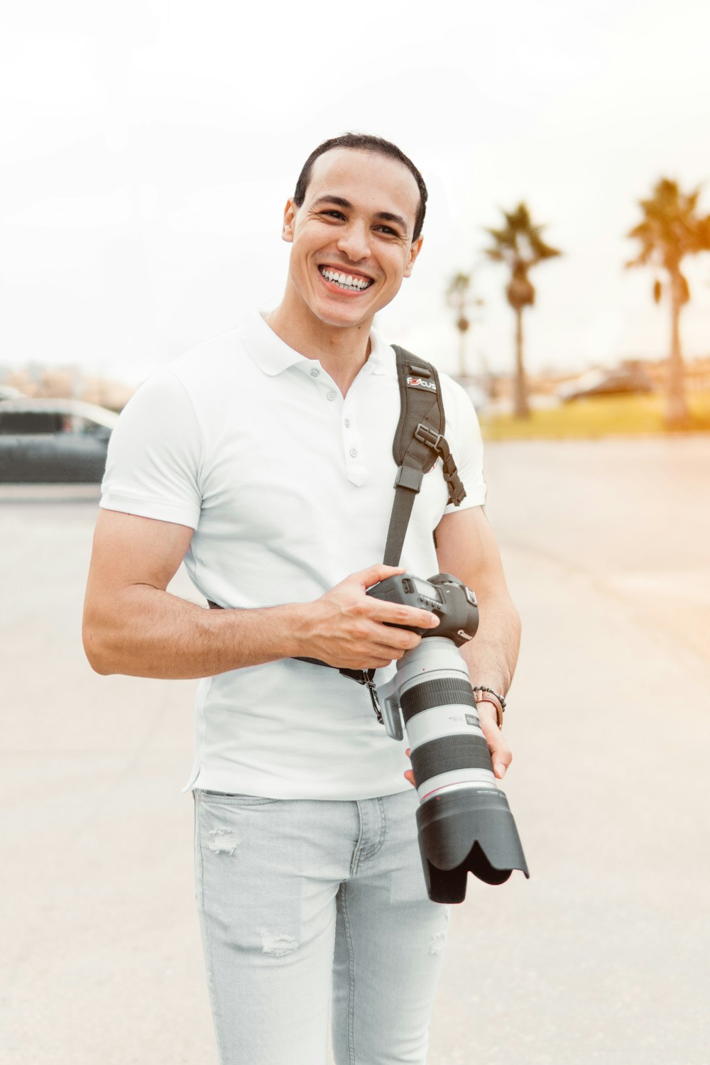 man holding gray and black DSLR camera