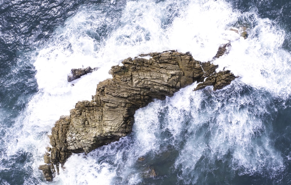 waves crashing on rock formation