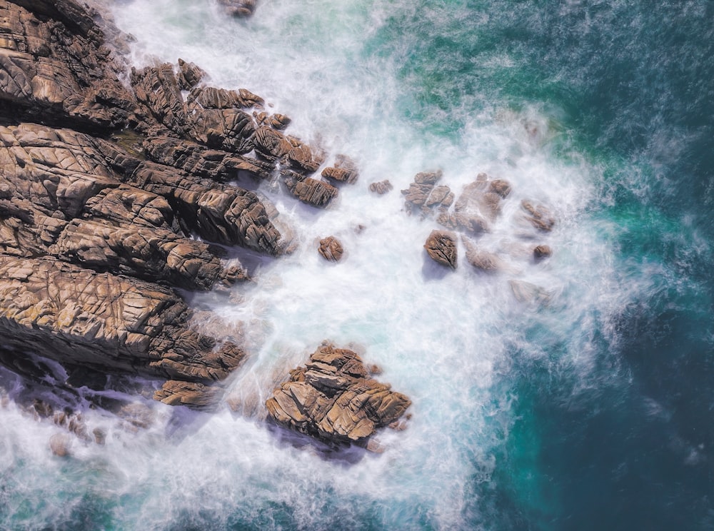 brown rock formation at the sea