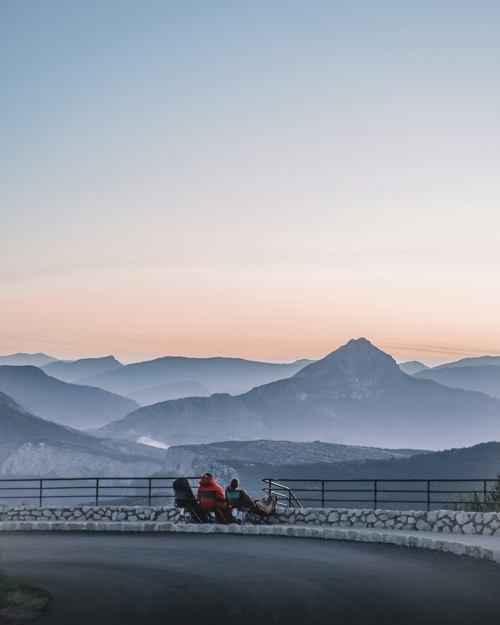 two persons looking at the mountain