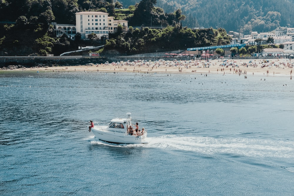 people riding white motorboat