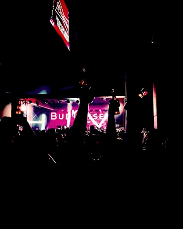A vibrant event banner reading 'Bud of the Year' hanging above a lively crowd.