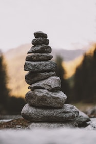 Close-up of stacked stones symbolizing balance and stability against a blurred natural background.