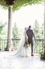 man and woman standing near railings