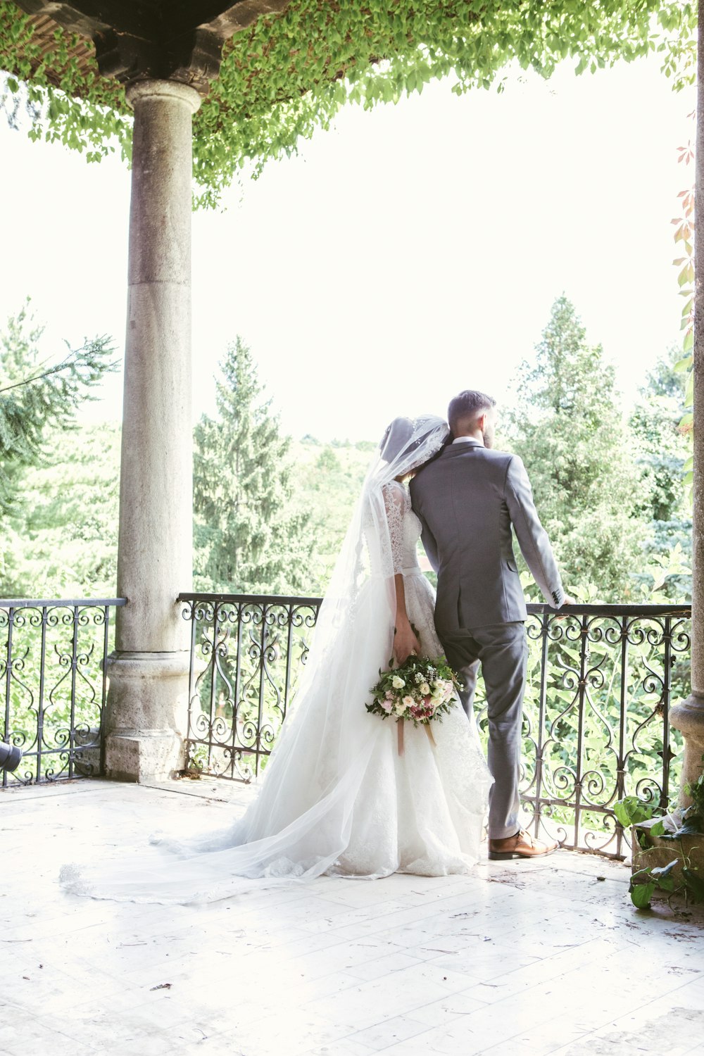 man and woman standing near railings