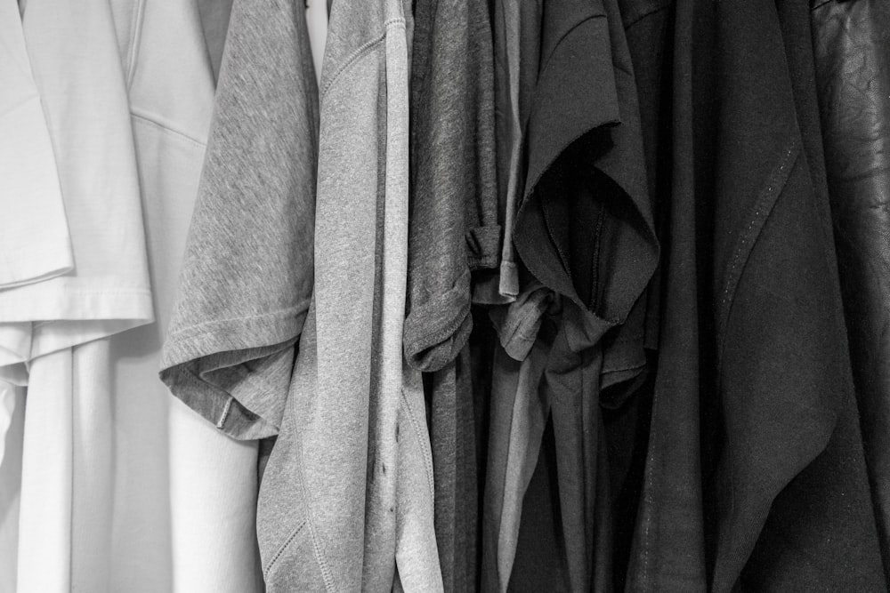 grayscale photography of assorted clothes