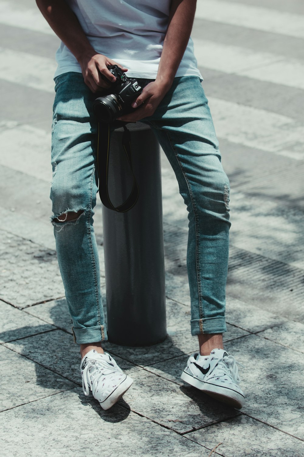 person's distressed blue jeans