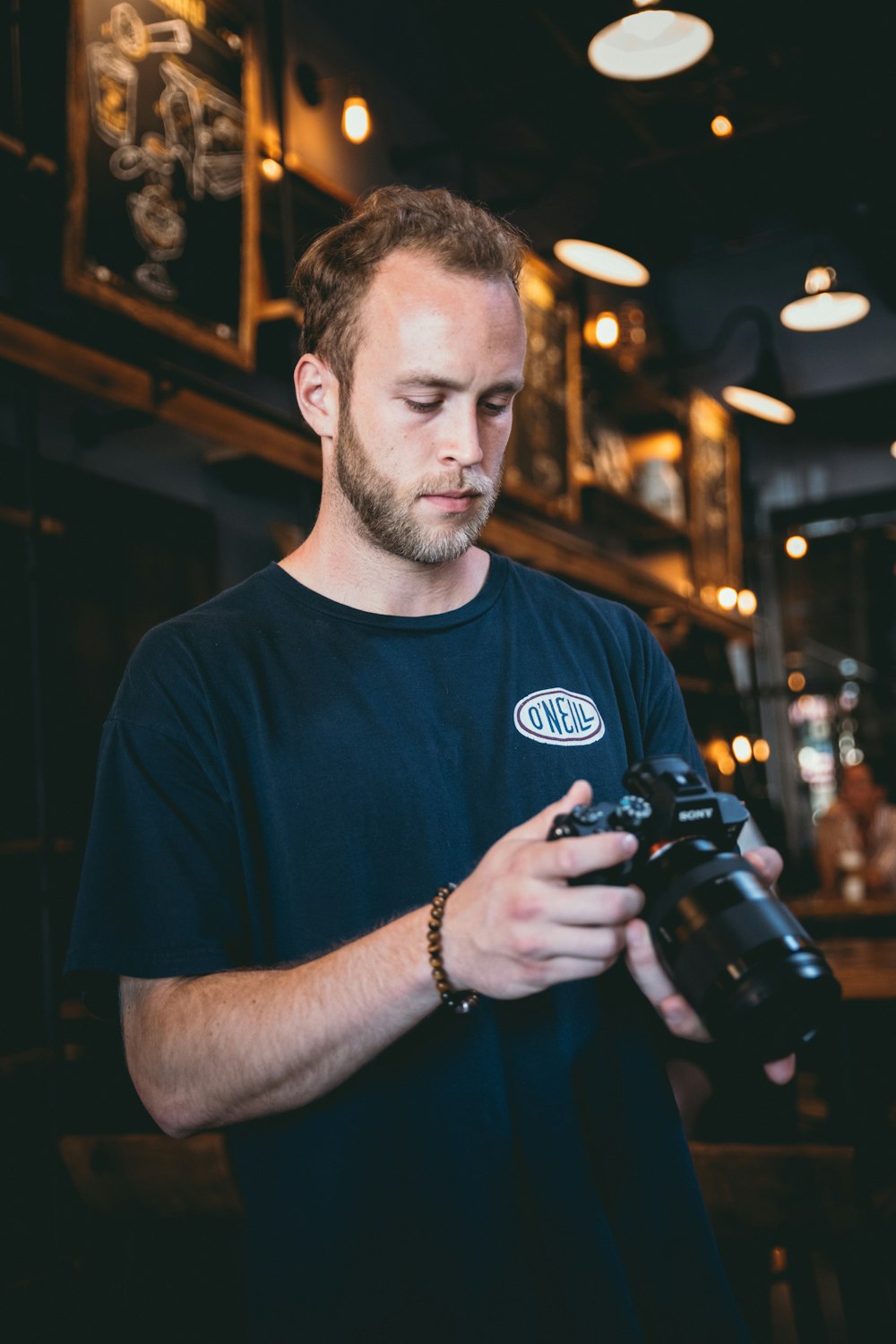 person holds DSLR camera