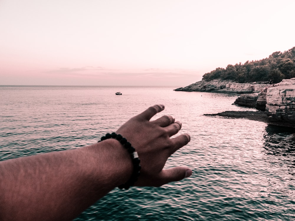 man wearing black beaded bracelet