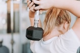 healthy activity - woman holding dumbbell in white crew-neck t-shirt