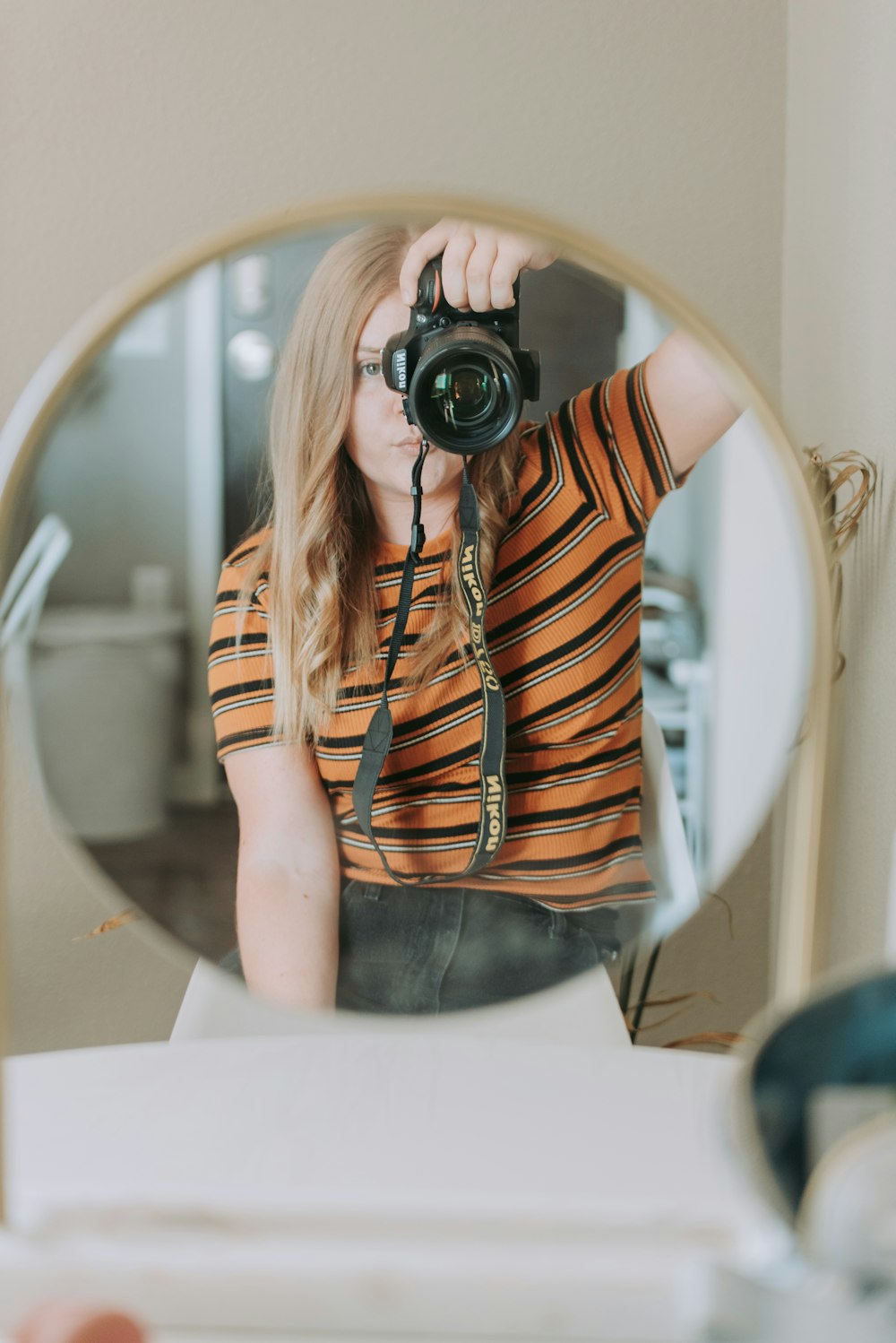 woman taking photo using black camera