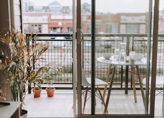 round glass-top table beside door