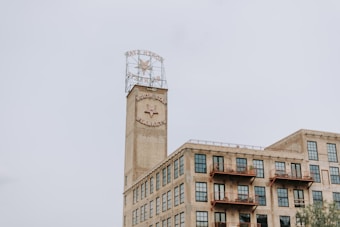 A historic industrial building with a prominent tower featuring a star logo and the words 'North Star Blankets.' The structure has multiple stories with large windows and balconies, indicating a converted warehouse or factory.