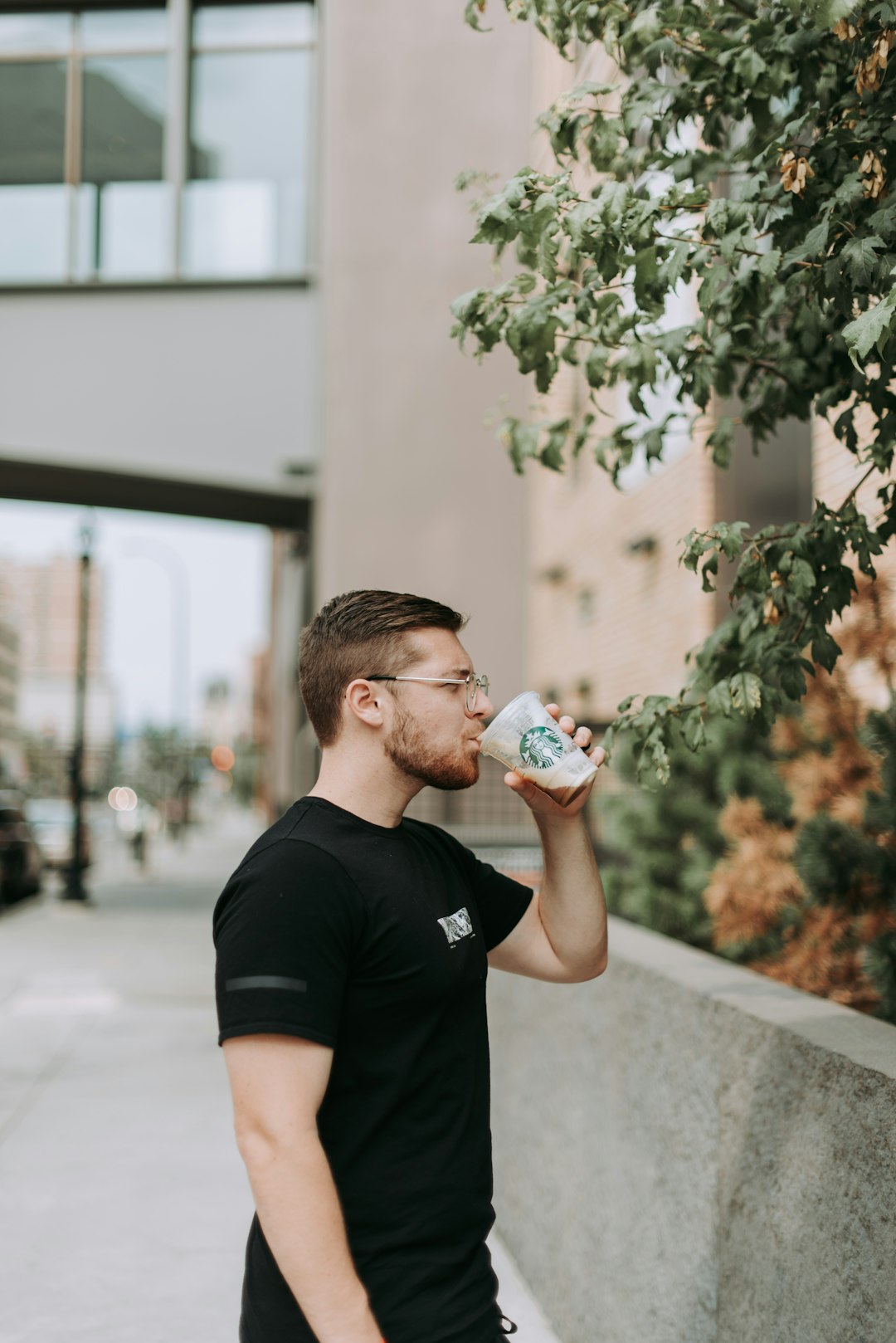 man drinking Starbucks coffee