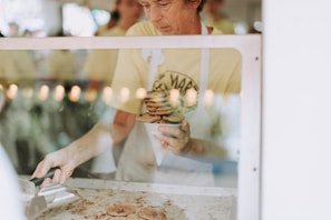 A cheerful baker packaging cookies with care, ready for local pickup.