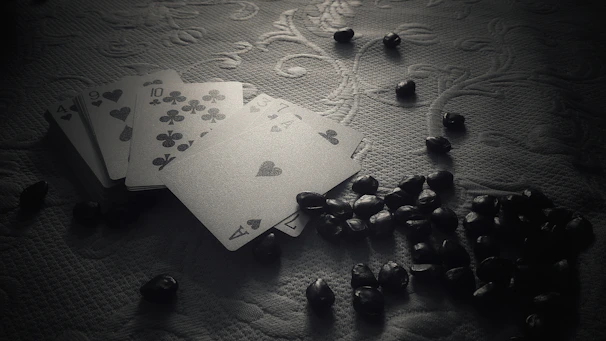 Magic: The Gathering cards fanned out on a dark surface with subtle glowing edges.
