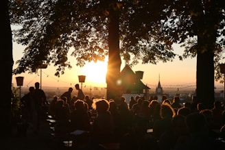 A beautiful sunset backdrop at an outdoor gathering.