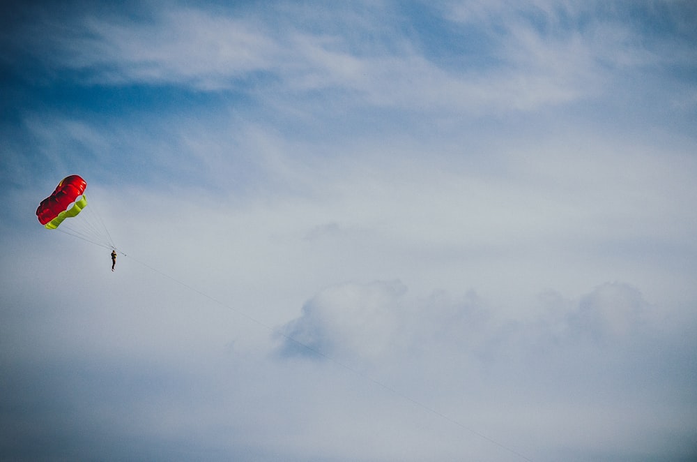 person paragliding under altocumulus clouds