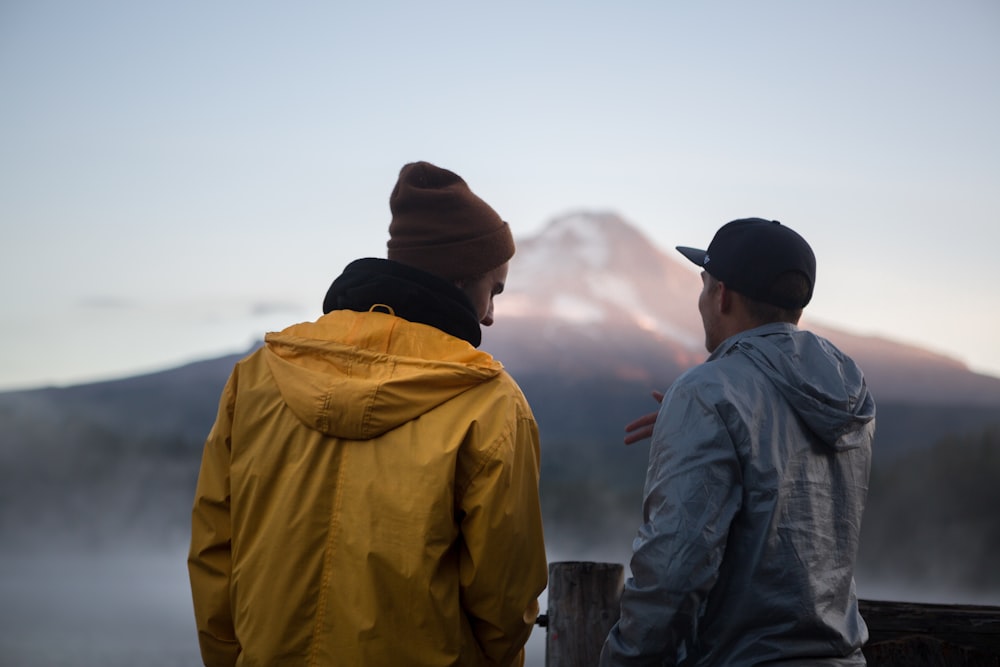 man standing beside man during daytime