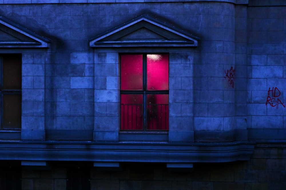 closed window building with red stained glass