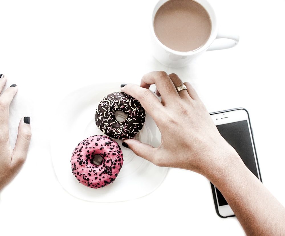 person holding doughnut